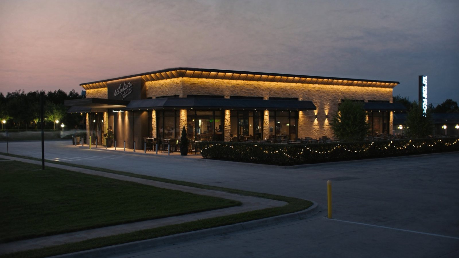 Freestanding commercial restaurant property at dusk